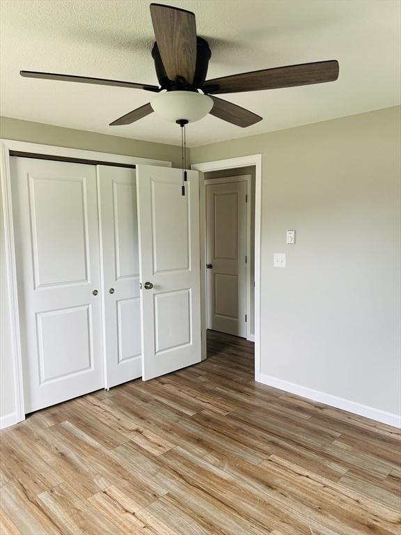 209 Casey Dr, Chicopee, MA 01020 - unfurnished bedroom with light wood finished floors, a closet, and a ceiling fan
