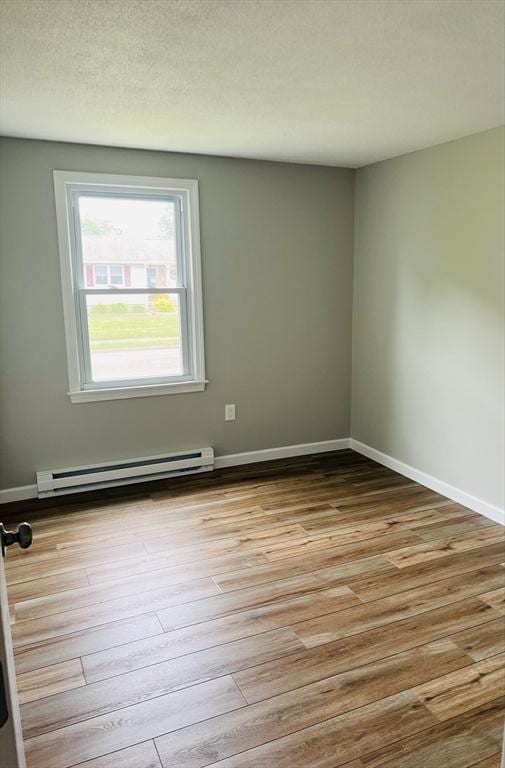 209 Casey Dr, Chicopee, MA 01020 - empty room featuring baseboard heating and wood finished floors