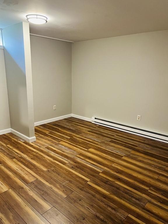 209 Casey Dr, Chicopee, MA 01020 - empty room featuring dark wood-type flooring and baseboard heating