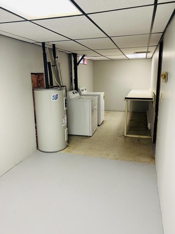 209 Casey Dr, Chicopee, MA 01020 - below grade area with electric water heater, washing machine and dryer, light flooring, and a drop ceiling