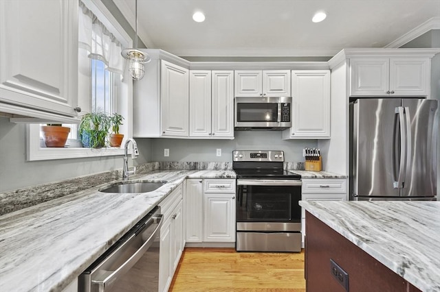 10 Stone St Unit 1, Auburn, MA 01501 - kitchen with light wood-style flooring, a sink, white cabinetry, and stainless steel appliances