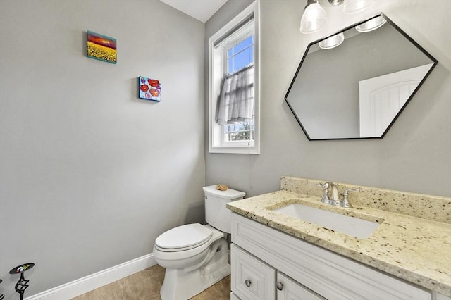 10 Stone St Unit 1, Auburn, MA 01501 - bathroom featuring toilet, baseboards, and vanity