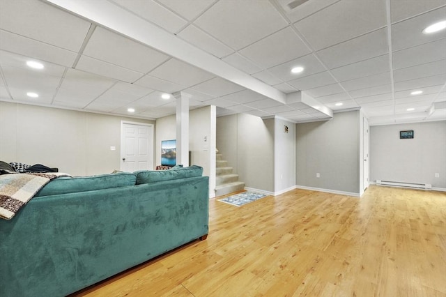 10 Stone St Unit 1, Auburn, MA 01501 - living room with a baseboard radiator, wood finished floors, baseboards, and stairway
