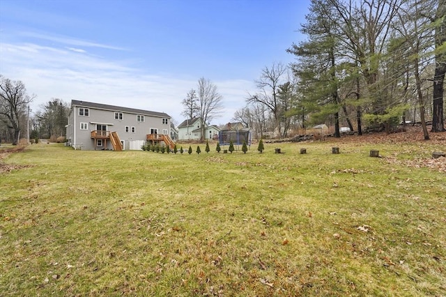 10 Stone St Unit 1, Auburn, MA 01501 - view of yard featuring a trampoline, a wooden deck, and stairway