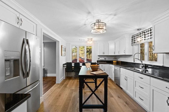 92 Martin St, Rehoboth, MA 02769 - kitchen with appliances with stainless steel finishes, white cabinetry, dark countertops, decorative light fixtures, and light wood finished floors