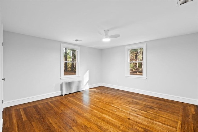 92 Martin St, Rehoboth, MA 02769 - unfurnished room featuring radiator, plenty of natural light, ceiling fan, and wood finished floors