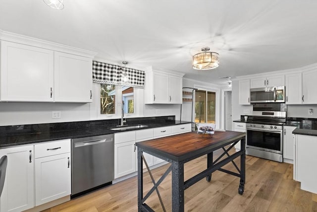 92 Martin St, Rehoboth, MA 02769 - kitchen with stainless steel appliances, white cabinets, light wood-style flooring, and dark countertops