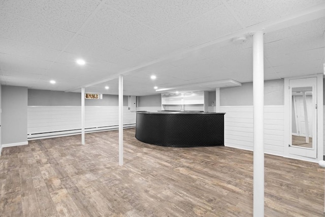 92 Martin St, Rehoboth, MA 02769 - finished basement featuring a baseboard heating unit, wood finished floors, and a paneled ceiling