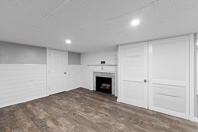 92 Martin St, Rehoboth, MA 02769 - unfurnished living room with wood finished floors, a paneled ceiling, a brick fireplace, and wainscoting