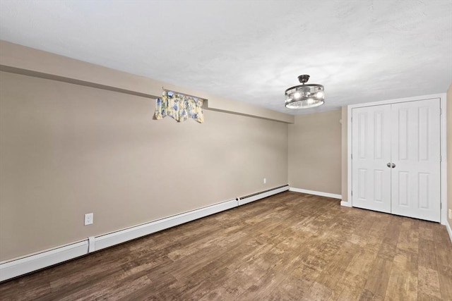 92 Martin St, Rehoboth, MA 02769 - unfurnished bedroom with wood finished floors, baseboard heating, and a closet