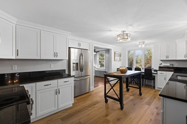 92 Martin St, Rehoboth, MA 02769 - kitchen with stainless steel fridge, range with electric stovetop, white cabinetry, and light wood-type flooring