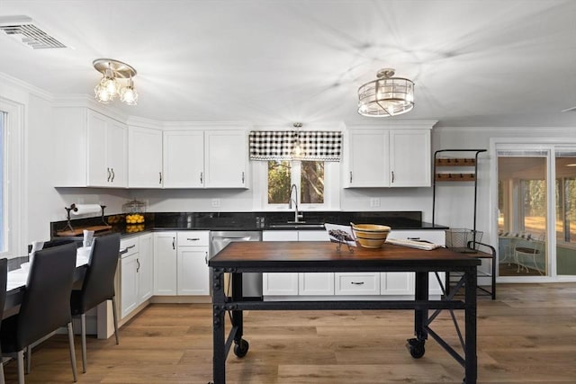 92 Martin St, Rehoboth, MA 02769 - kitchen with white cabinetry, a chandelier, wood finished floors, and ornamental molding