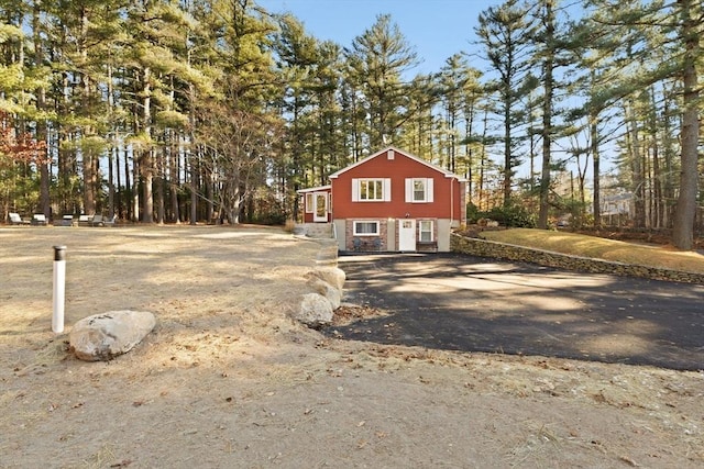 92 Martin St, Rehoboth, MA 02769 - view of home's exterior with asphalt driveway, view of scattered trees, and stone siding