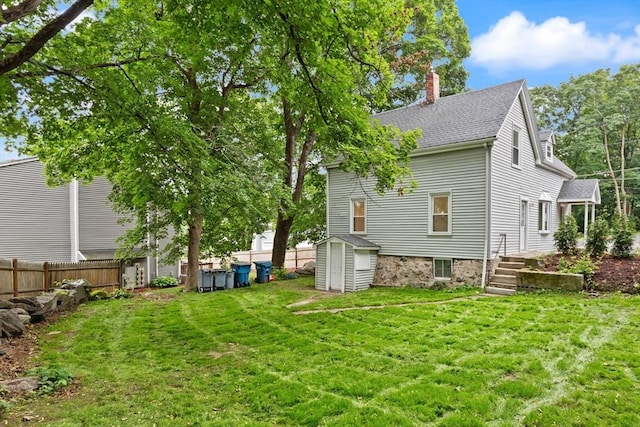 25 Norfolk St, Canton, MA 02021 - rear view of property featuring a storage shed, a chimney, and roof with shingles