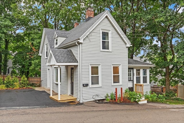 25 Norfolk St, Canton, MA 02021 - view of front of property with roof with shingles and a chimney