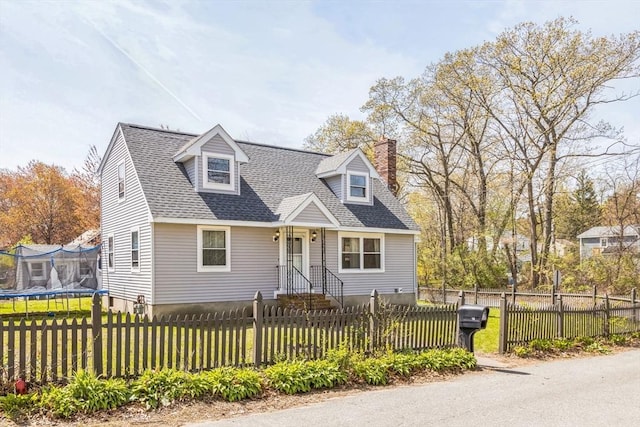 14 Greenville St, Billerica, MA 01821 - cape cod house with a fenced front yard, a chimney, a trampoline, and a front lawn