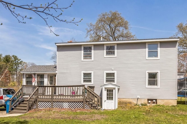 14 Greenville St, Billerica, MA 01821 - back of property with a sunroom, a trampoline, a wooden deck, and a yard