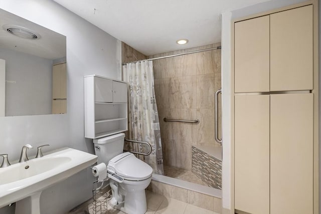 bathroom with a sink, toilet, tile patterned floors, a shower stall, and visible vents
