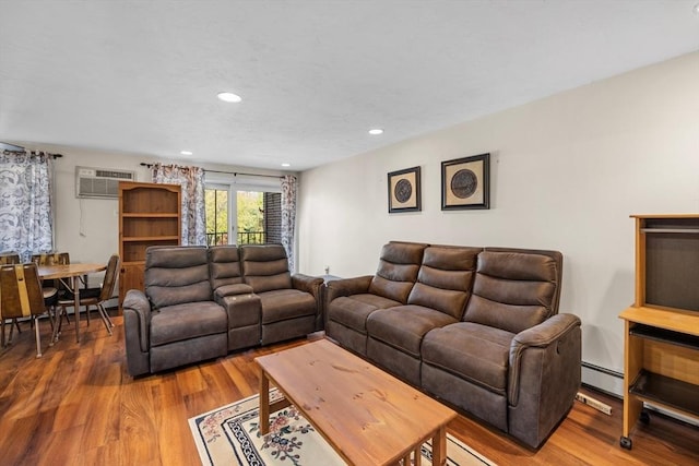 living room featuring an AC wall unit, recessed lighting, baseboard heating, and wood finished floors