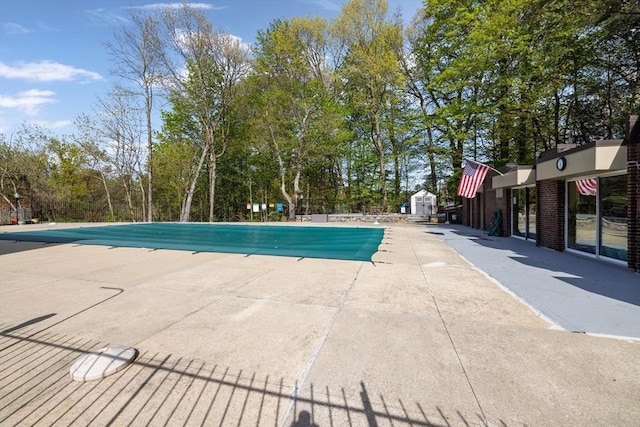 view of pool featuring a patio and a covered pool