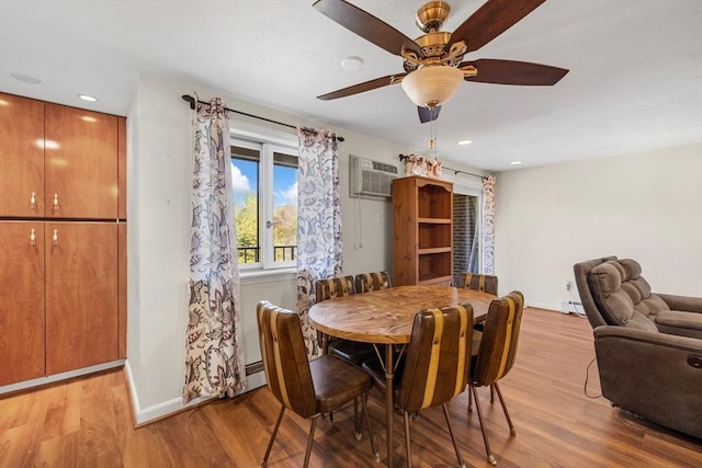 dining room featuring baseboards, ceiling fan, a wall mounted air conditioner, and light wood-style floors