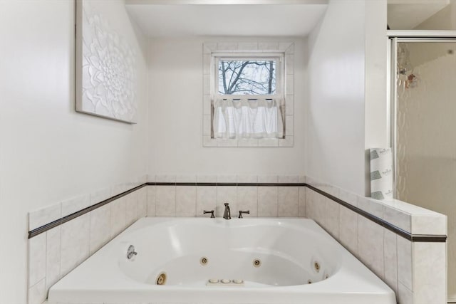 bathroom featuring shower with separate bathtub