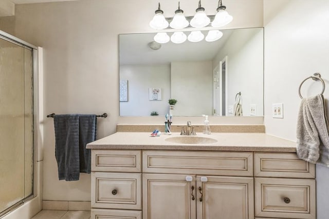 bathroom featuring vanity, an enclosed shower, and tile patterned flooring