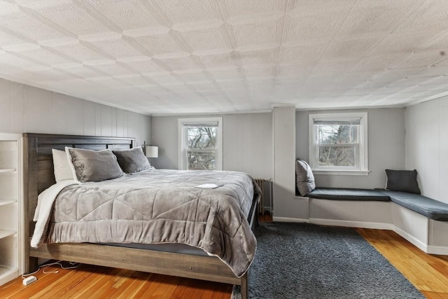 bedroom featuring hardwood / wood-style flooring and multiple windows