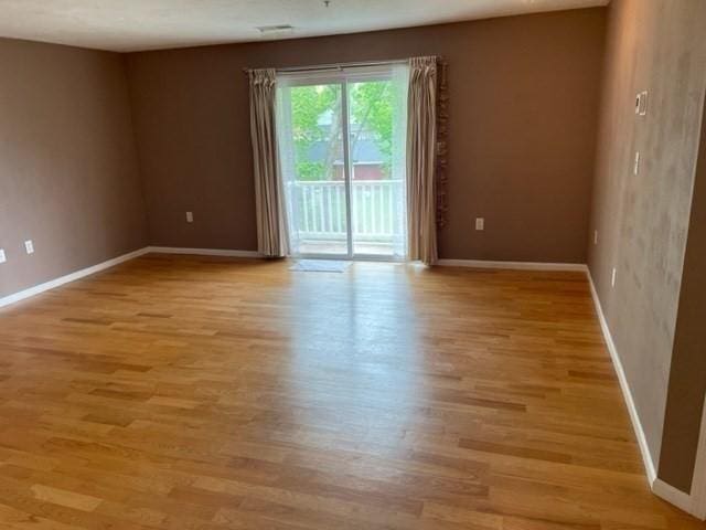 unfurnished room featuring light wood-type flooring and baseboards