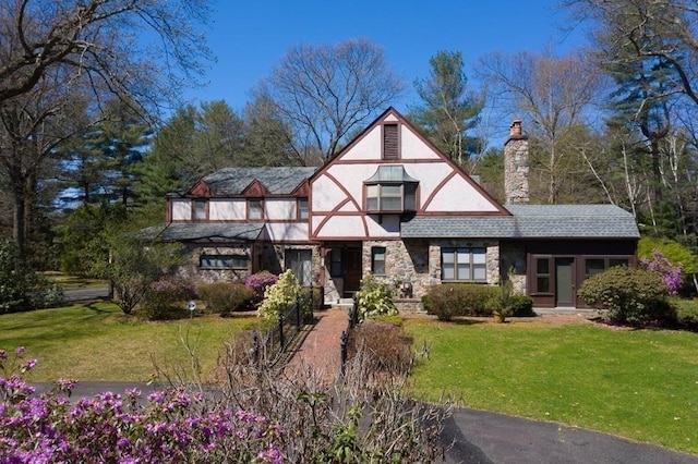 242 Eastwood Dr, Westfield, MA 01085 - tudor home featuring a chimney, a front lawn, and stone siding
