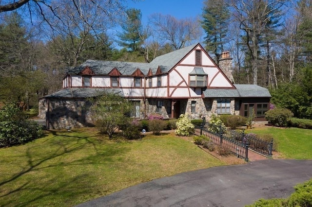 242 Eastwood Dr, Westfield, MA 01085 - english style home featuring a chimney, a front yard, and stone siding