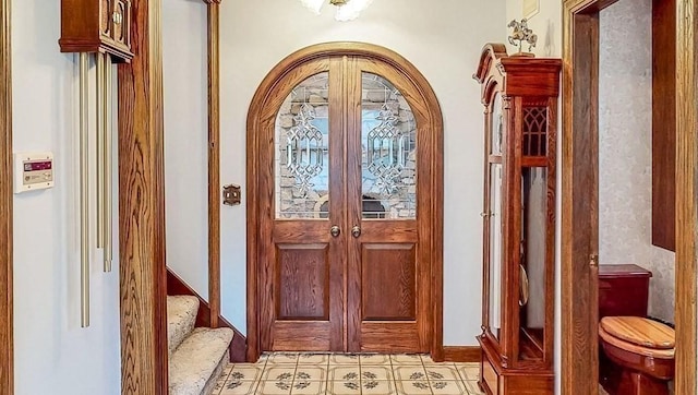 242 Eastwood Dr, Westfield, MA 01085 - foyer with arched walkways, light floors, stairway, and baseboards