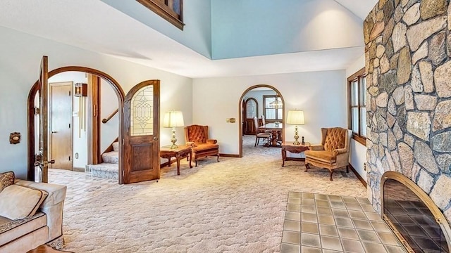 242 Eastwood Dr, Westfield, MA 01085 - living area with carpet floors, arched walkways, stairs, baseboards, and a towering ceiling