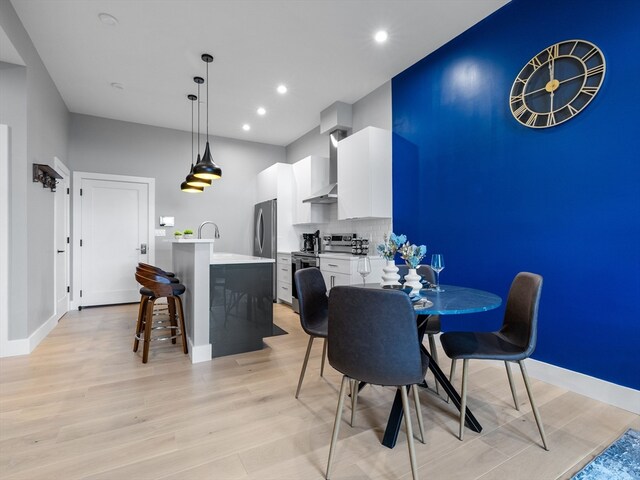 dining space with light hardwood / wood-style floors