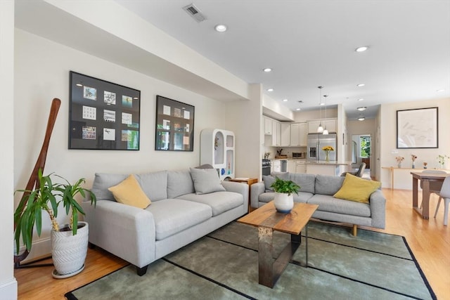 129 Highland Ave Unit 4, Somerville, MA 02143 - living area with light wood-style flooring, recessed lighting, and arched walkways