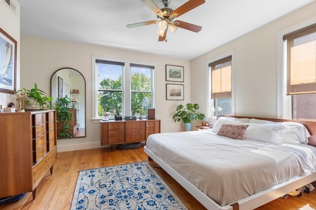 129 Highland Ave Unit 4, Somerville, MA 02143 - bedroom with multiple windows, light wood finished floors, and a ceiling fan