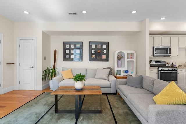129 Highland Ave Unit 4, Somerville, MA 02143 - living area featuring light wood-style floors and recessed lighting