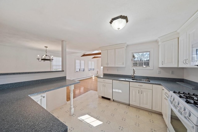 kitchen with white appliances, dark countertops, and a sink