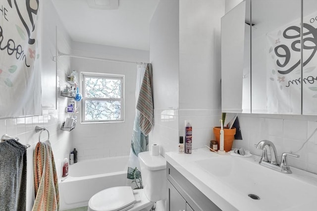 full bathroom with tile walls, decorative backsplash, vanity, shower / tub combo, and toilet