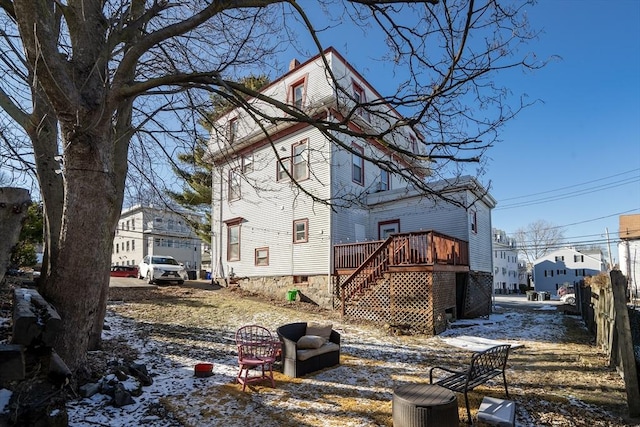 view of snowy exterior featuring a deck