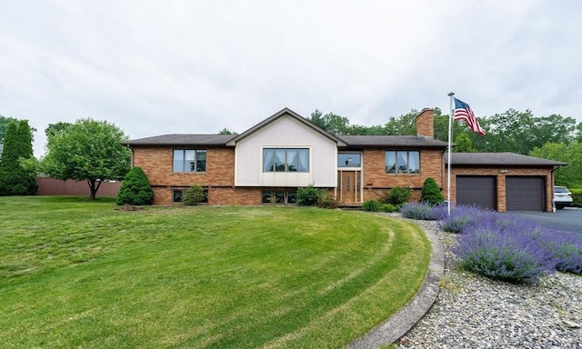1170 E St, Ludlow, MA 01056 - view of front of house with a garage, a chimney, brick siding, and driveway