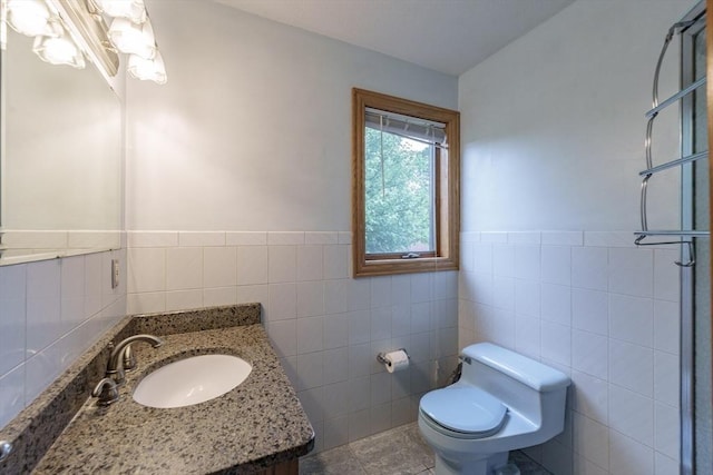 1170 E St, Ludlow, MA 01056 - bathroom featuring tile walls, vanity, a shower, and a wainscoted wall