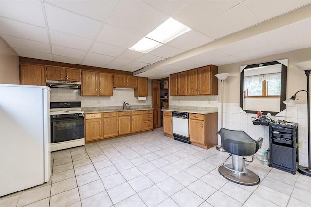 1170 E St, Ludlow, MA 01056 - kitchen featuring white appliances, under cabinet range hood, light countertops, brown cabinets, and a drop ceiling
