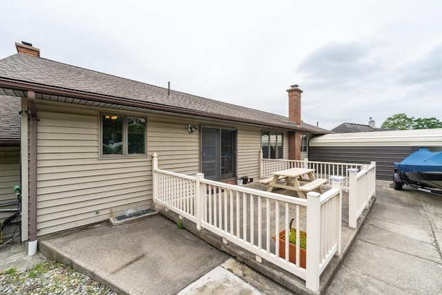 1170 E St, Ludlow, MA 01056 - rear view of house with a chimney and a deck