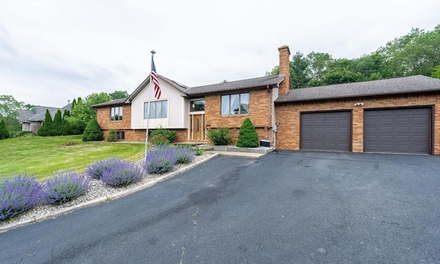 1170 E St, Ludlow, MA 01056 - view of front of home with a front yard, a chimney, and brick siding