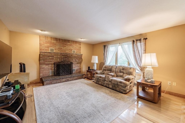 1170 E St, Ludlow, MA 01056 - living area with wood finished floors and a brick fireplace