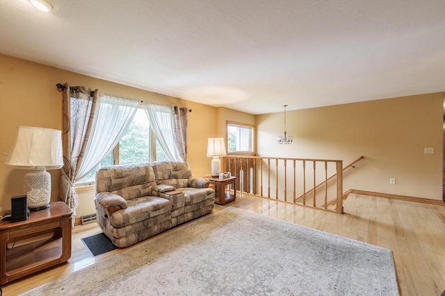1170 E St, Ludlow, MA 01056 - living room with wood finished floors and a chandelier