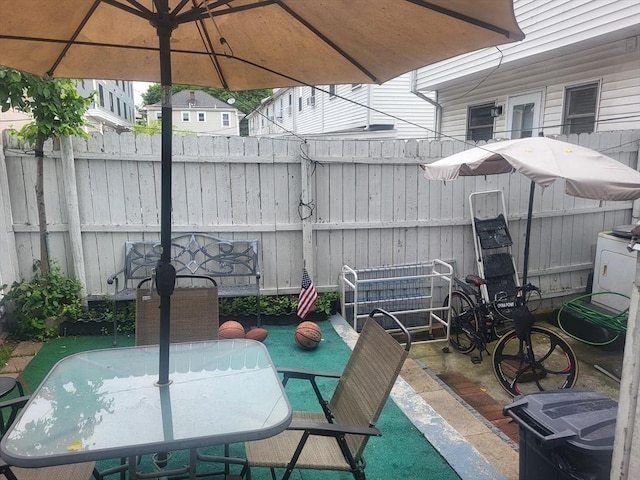 21 Delford Unit 2, Boston, MA 02131 - view of patio / terrace with outdoor dining space and washer / dryer