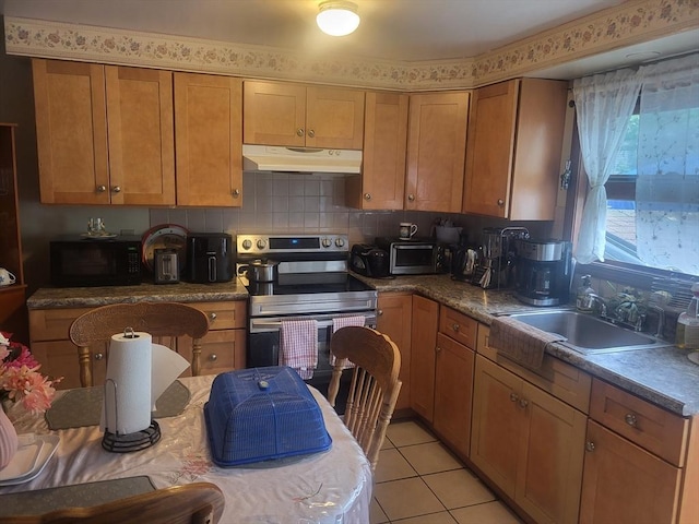 21 Delford Unit 2, Boston, MA 02131 - kitchen with stainless steel electric range, under cabinet range hood, black microwave, brown cabinetry, and light tile patterned floors