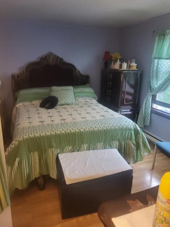 21 Delford Unit 2, Boston, MA 02131 - bedroom with wood finished floors and a baseboard radiator
